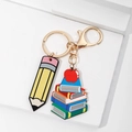 Detail of pencil and apple stack keychain for teacher gift on white geometric background - Apple Books Wood Board And Pencil