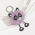 Detail of purple plush raccoon keychain featuring soft fur texture and silver metal ring - Purple