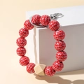 Detail of red beaded keychain bracelet with XOXO heart print and metal lobster clasp - XOXO Letters