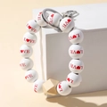 Leopard print wood bead keychain bracelet with LOVE letters and heart on white pedestal - LOVE Letter