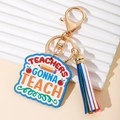 Rainbow teacher keychain with colorful tassel and gold lobster clasp on white background - Wave Shape Plaque With Tassel