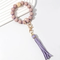 Detail of candy purple checkered wooden bead keychain with soft PU leather fringe - Purple