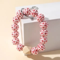 Detail of beaded keychain with red lip prints, XOXO text and a wooden hexagonal bead - Lipstick Printed