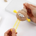 Detail showing elastic spring limbs and plush texture of the cute monster keychain - Khaki