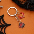 Halloween Schlüsselanhänger mit Fledermaus und Spinne auf einem orangenen Hintergrund - Gold & Rot Fledermaus mit Spinne