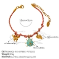Pink braided bracelet with gold butterfly, ladybug, and grape charms in stainless steel - Butterfly Ladybug Grapes Pendant Bracelet (SL385RBG14)