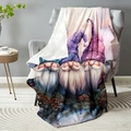 Flannel blanket with three Christmas Gnomes design draped over a modern grey sofa chair - Three Christmas Gnomes Print / 100x150cm