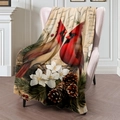 Vintage flannel blanket featuring red cardinal and pine cone digital print on pink chair - 100x150cm