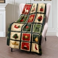Christmas flannel throw blanket with vintage reindeer and tree stamp print on sofa - 100x150cm