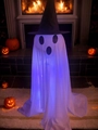 Close-up of glowing Halloween ghost with purple LED lights near a warm fireplace - White Blue-Purple Light (YL-05)