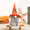 Halloween gnome with orange pumpkin hat and gray beard sitting on a miniature wooden bench - Orange Pumpkin