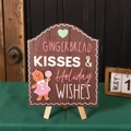 Nahaufnahme von Lebkuchen-Kuss-Holzschild mit Mini-Stativständer auf grüner Oberfläche - Kaffee Weiblicher Lebkuchenstil Mit Ständer