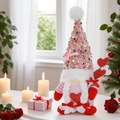 Valentine's Day gnome doll with sequin hat and red heart on a romantic table setting - Female Style With Heart Stick