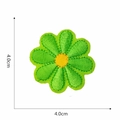 Detail view of a 4.0cm green embroidered flower patch with a yellow center and precise edges - Green Yellow Core Daisy