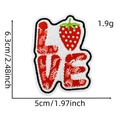 Detail showing LOVE embroidery patch with strawberry design and dimensions 6.3cm by 5cm - LOVE Strawberry