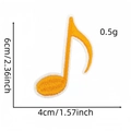 Detailed view of an orange musical note patch with size dimensions and embroidery texture - Orange Eighth Note Variant