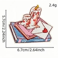 Cute pink embroidered candle and book patch for clothing with size measurements - Candle Envelope
