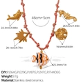 18K gold plated stainless steel ocean charm necklace with pink woven cord and ceramic fish - Dolphin Seahorse Ceramic Fish Necklace (XL785PKG7)