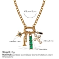 Gold stainless steel chain necklace with green stone, pearl cross and horn charms - XL696CRG Gold Necklace