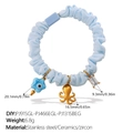 Light blue scrunchie with octopus and evil eye star charms in a minimalist design - Blue Star Ceramic Octopus Rectangle Rhinestone Style (FQ01LB-PJ915GL-PJ466EGL-PJ1315BEG)
