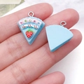 Detailed view of handmade resin strawberry cake charm with silver metal eyelet hook - Lake Blue