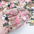 Detailed macro view of colorful enamel western cowboy charms held in a hand for DIY jewelry - Random 10Pcs Enamel Western Cowboy Series (SN1316)