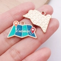 Detailed close-up of a vacation map alloy pendant featuring white vacation lettering - Map (Vacation) - Blue