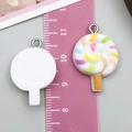Lollipop resin pendant with colorful spiral design and silver metal ring shown with ruler - White Lollipop