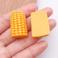 Hars bedeltjes in de vorm van maïs en koekjes voor DIY kettingen en sleutelhangers - Halve Mais (24637) / 1 Stuk (31x19x11mm) / Geel