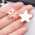 Macro detail of cartoon starfish resin pendants showing front and back design - Light Brown Starfish (24759)
