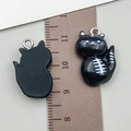 Detail view of 2cm resin cat pendants with skull face and silver rings for DIY jewelry making - 22x15x7mm / Black Resin Cat