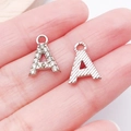 Macro shot of silver-tone letter A charms with rhinestone pavé and textured finish - Letter A / 13x10mm