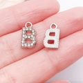 Detailed macro view of diamond-encrusted and textured metal letter B DIY jewelry pendants - Letter B / 13x7mm