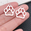 Silver hollow pet paw charms for DIY jewelry making held by finger for size - Large Bright Silver Paw 20x17mm (20654)
