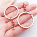 Polished rose gold metal keychain ring with short tail chain shown held in hand - Rose Gold with Chain Style (25826)