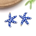 Detailed view of blue starfish charms with white dots and gold plating for DIY jewelry - Medium / Medium Royal Blue Polka Dot Style (T1235)