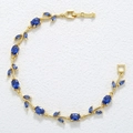 Detailed macro view of the golden vine leaf bracelet with deep blue marquise-cut stones - Gold Blue Tulip Bracelet