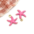 Close-up of pink starfish charms with gold plating for DIY jewelry making - Small Gold Rose Red Style (T1170)
