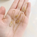 Delicate gold micro-pave zircon letter threader earrings held in hand to show size - Alphabet A Ear Thread Only