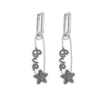 Detail view of silver safety pin earrings with black stones spelling Love and a star - Platinum Black Zirconia