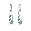 Macro detail of silver safety pin earrings with green crystals and star love charms - Platinum Green Stone