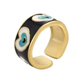 Detailed macro view of wide gold band ring featuring black enamel heart evil eye patterns - Black