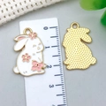 Detailed view of white enamel bunny pendants with cherry blossoms and measurement scale - White Flower Rabbit Style (23160)