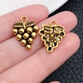 Macro shot of vintage gold grape pendant showing intricate details and backside view - Vintage Grape Shape