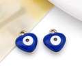 Detailed view of two blue enamel heart-shaped evil eye charms with golden metal edges - Heart / Sapphire Blue