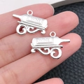 Close-up of vintage silver alloy wine bottle pendant with wine engraving and metal rack - Wine Bottle Accessory