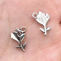 Silver tulip flower charms for DIY jewelry making held in hand for scale - Flower Rose Charm 11x15mm (10404)