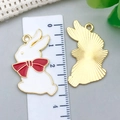 DIY rabbit charm pendant in white enamel with red bow, showing size with a ruler - Bowknot Rabbit Style (23161)