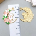 Detail of enamel rabbit moon pendants with cherry blossom design and gold textured back - Pink Moon Sakura Rabbit Wreath (23173)