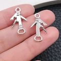 Detailed macro view of vintage silver alloy corkscrew charms held between fingers - Wine Corkscrew Style / Antique Silver (10551)